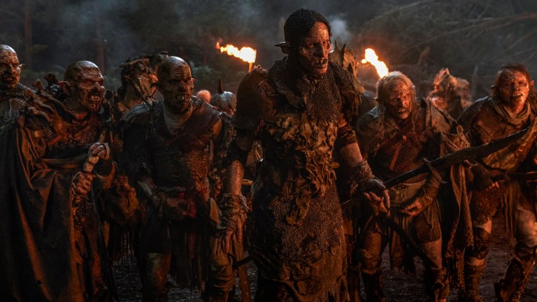 Orcs led by Robert Strange as Glûg (center, holding spear) in The Rings of Power